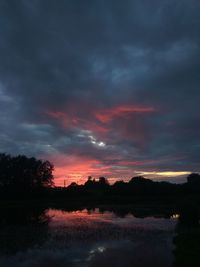 Scenic view of lake against romantic sky at sunset