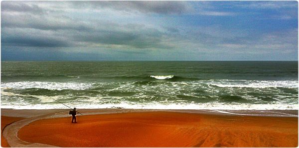 Scenic view of sea against cloudy sky