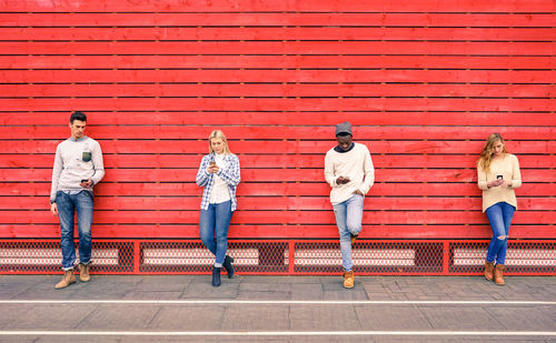 People using phones while standing on street