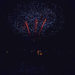 Low angle view of firework display at night