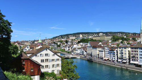 High angle view of townscape by river against sky