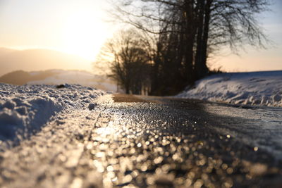 Surface level of snow covered land during sunset