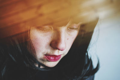 Close-up portrait of young woman with eyes closed