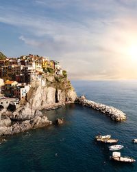 Scenic view of sea by buildings against sky