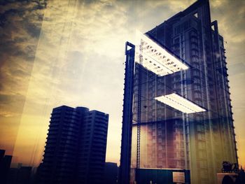 Low angle view of building against cloudy sky