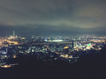 Aerial view of city lit up at night