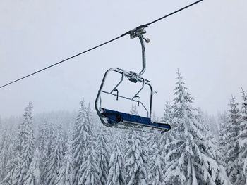 Overhead cable car on snow covered land