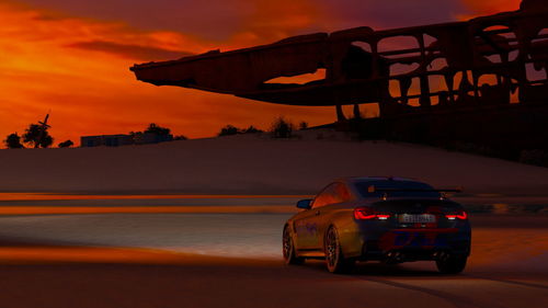 Car on road against sky during sunset