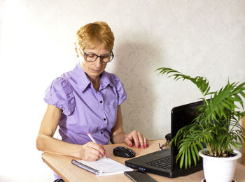Portrait of senior man using laptop at home