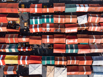 Zenithal view of the colored curtains of the stalls of an italian market