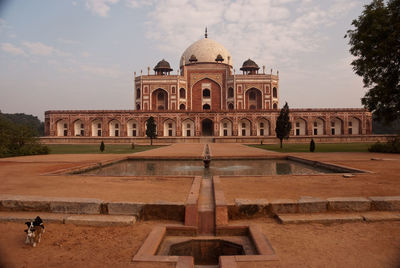 Reflecting pool in front of humayan tomb against sky