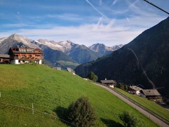 Houses by mountains against sky