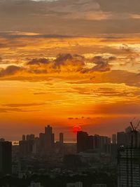 Cityscape against sky during sunset