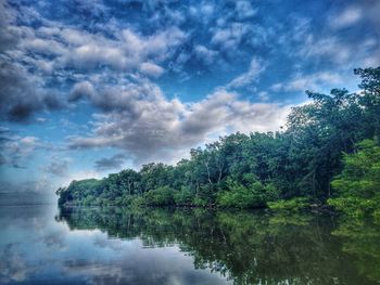 Reflection of trees in lake against sky