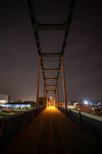 Illuminated bridge against sky at night