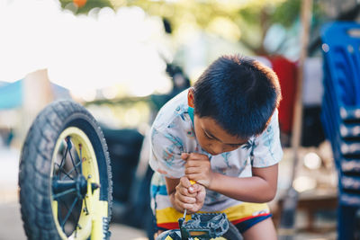 Rear view of boy looking at bus