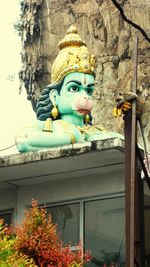 Low angle view of statue against building