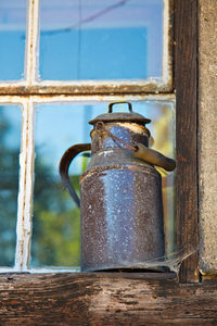 Close-up of rusty metal by window