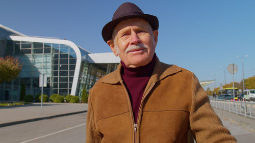 Portrait of man during sunny day in city