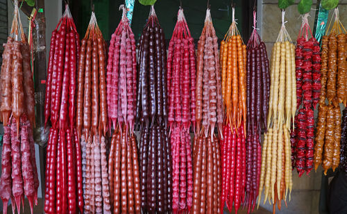 Close-up of various hanging for sale at market stall