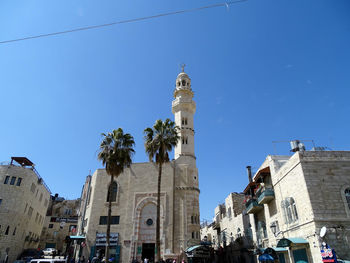 Statue in city against clear sky