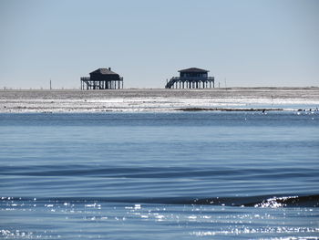 Two distant houses on sunny beach