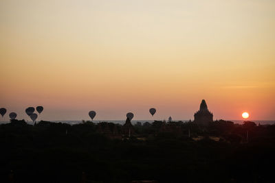 Silhouette of hot air balloon against sky during sunset