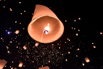 Low angle view of illuminated lanterns at night