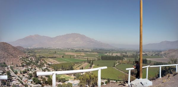 Scenic view of field and mountains against clear sky