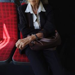 Old fashion lady in the bus with white collar and costume