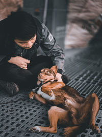 Man with dog sitting outdoors