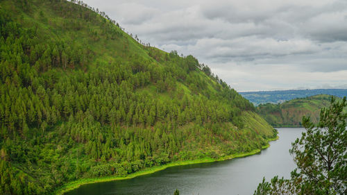 Scenic view of green mountains against sky