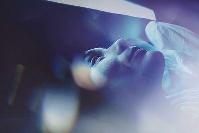 Close-up of woman sleeping on bed