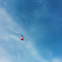 Low angle view of power lines against sky