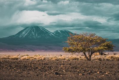 Scenic view of mountain against cloudy sky