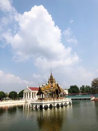 View of building by lake against cloudy sky thailand king summer palace