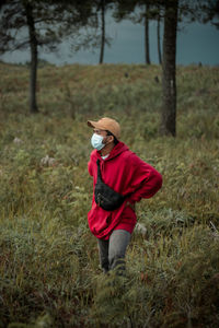 Man wearing mask standing on field