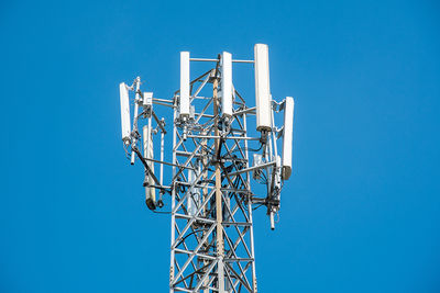 Low angle view of communications tower against clear sky