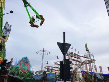 Low angle view of chain swing ride against sky