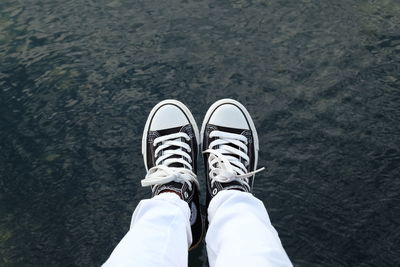 Low section of man standing on ground
