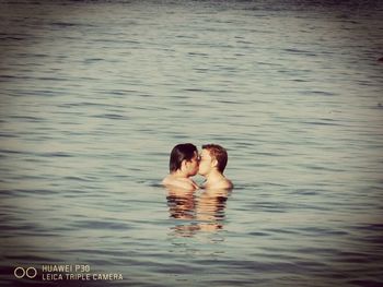 Couple swimming in sea