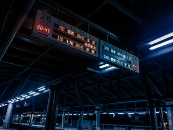 Low angle view of illuminated sign at subway station