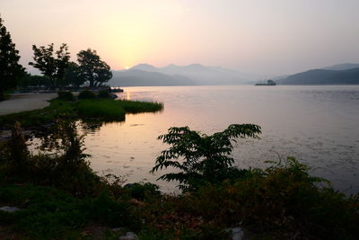 Scenic view of lake against sky during sunset