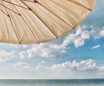 Cropped parasol against sky