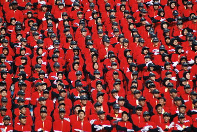 Full frame shot of people standing in red uniform during celebration