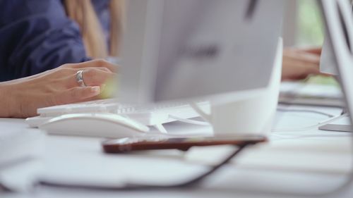 Midsection of woman using mobile phone