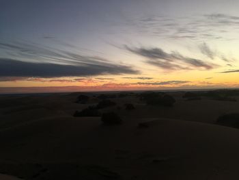 Scenic view of silhouette land against sky during sunset