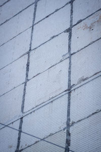 Low angle view of fence against building