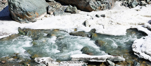 Scenic view of river flowing during winter