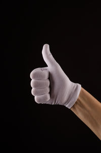 Close-up of human hand against black background